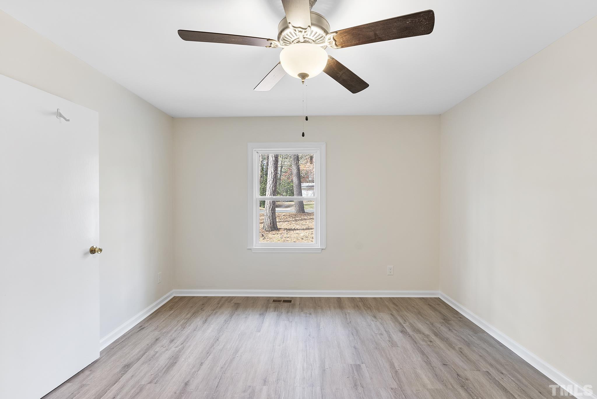 2125 Strebor Street Durham, NC 27705 - Photo 22 of 38 an empty room with a window and wooden floor