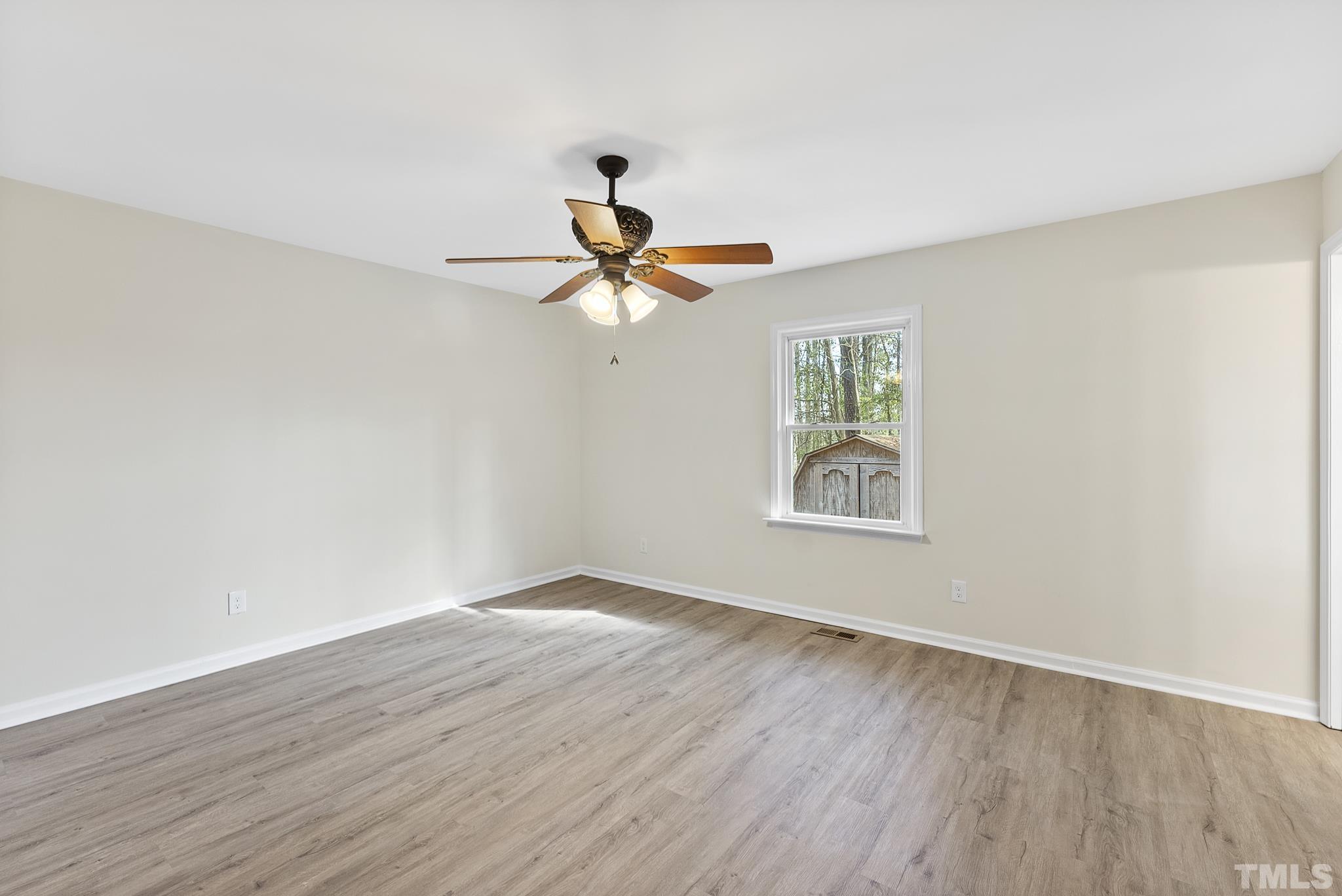 2125 Strebor Street Durham, NC 27705 - Photo 23 of 38 a view of a room with wooden floor ceiling fan and window