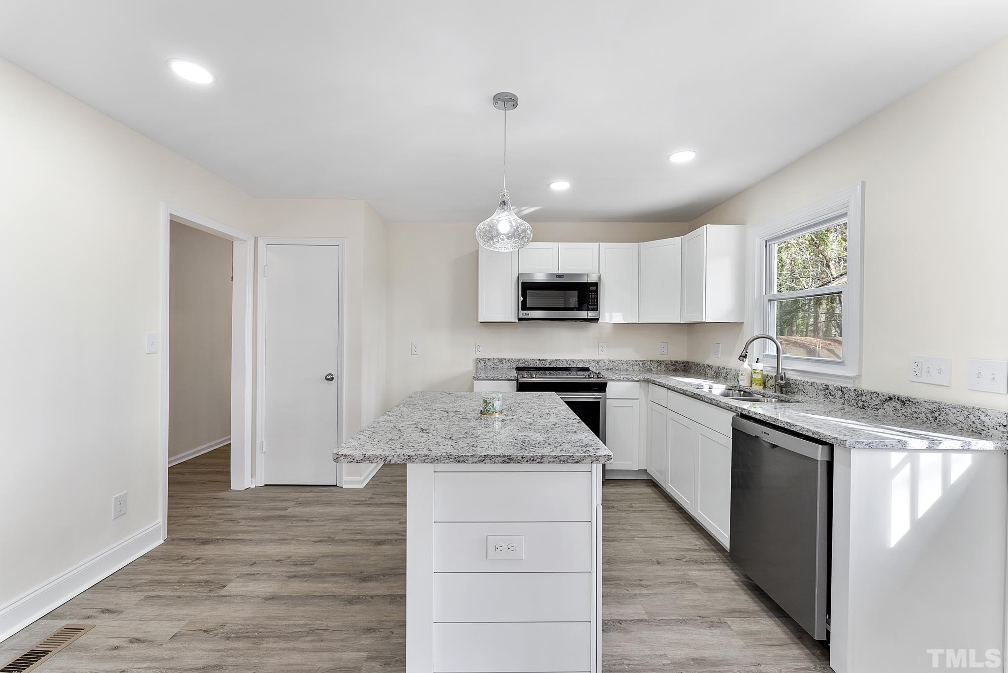 2125 Strebor Street Durham, NC 27705 - Photo 5 of 38 a kitchen with granite countertop a sink stove and refrigerator