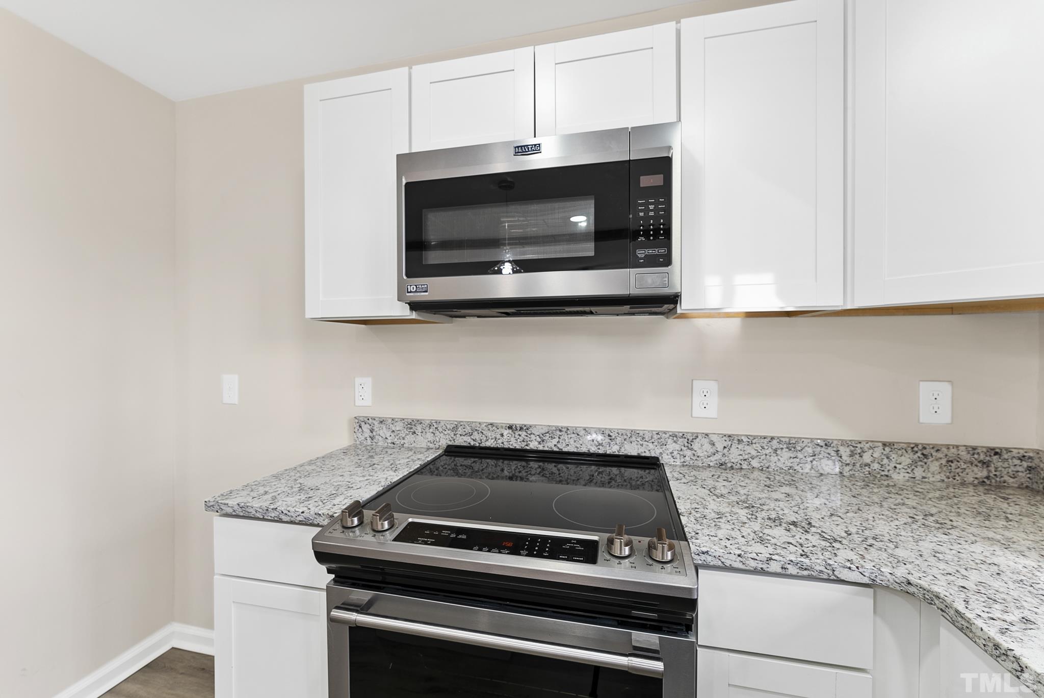 2125 Strebor Street Durham, NC 27705 - Photo 7 of 38 a kitchen with a stove and a microwave