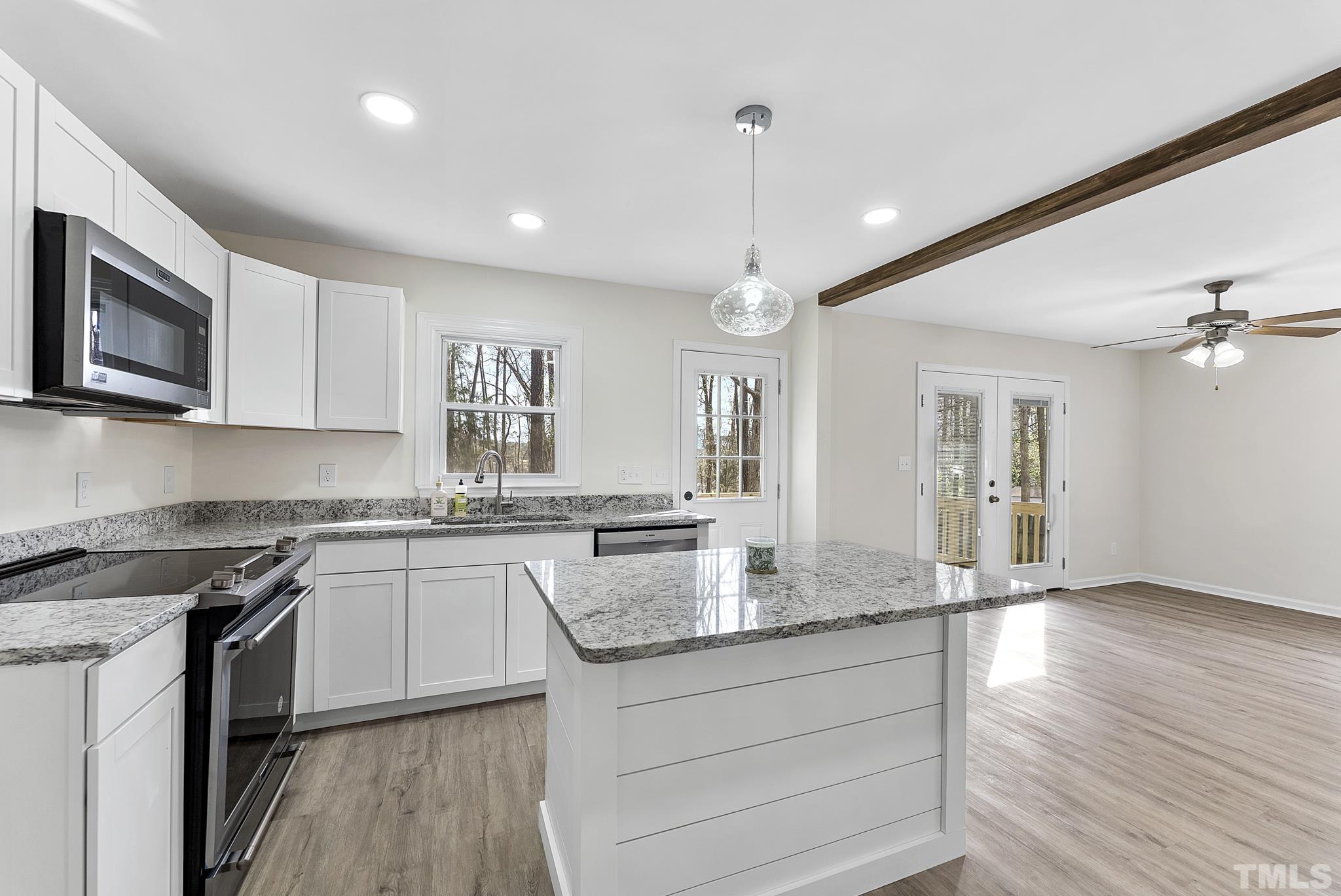2125 Strebor Street Durham, NC 27705 - Photo 8 of 38 a kitchen with granite countertop cabinets stainless steel appliances a sink and a stove