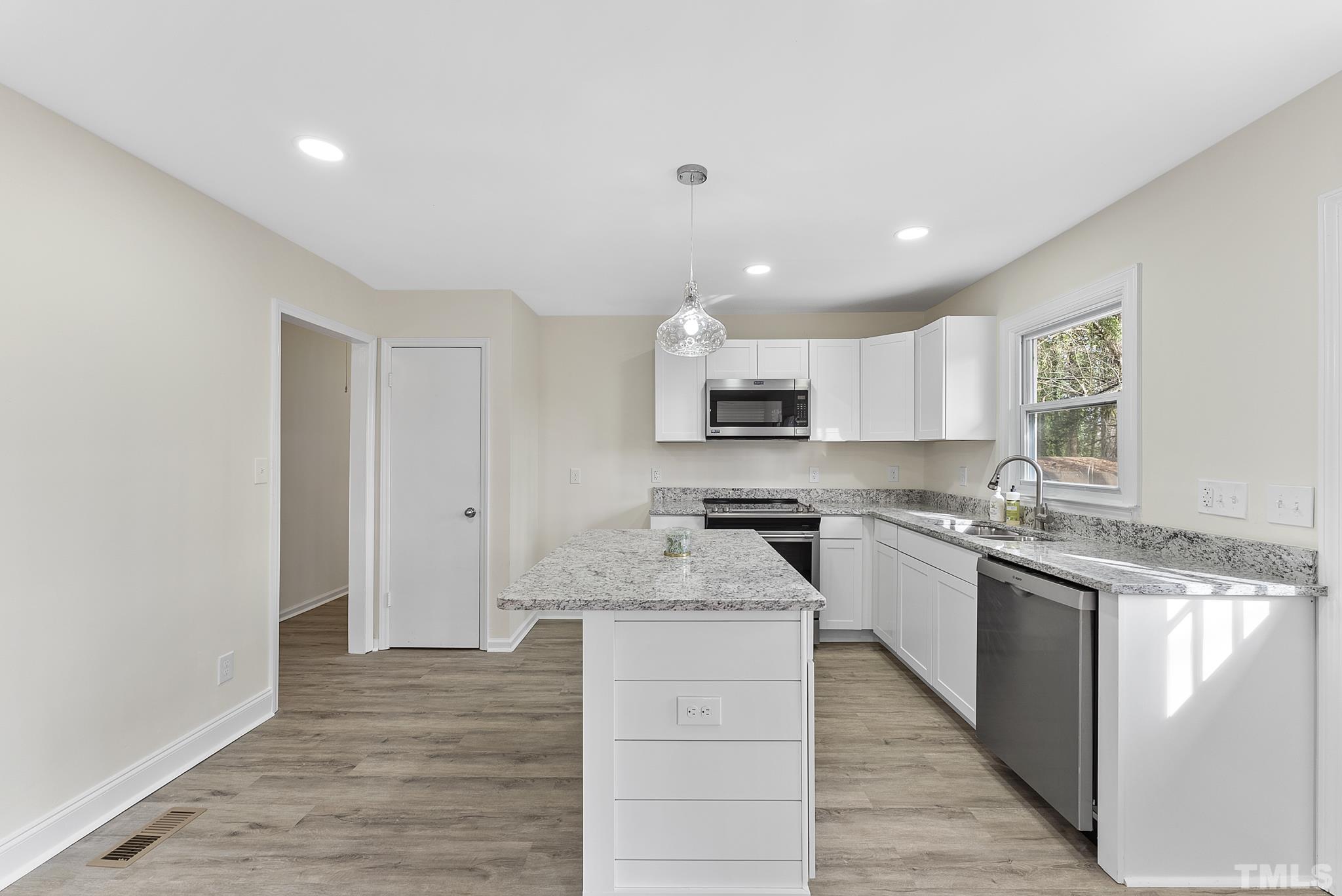 2125 Strebor Street Durham, NC 27705 - Photo 9 of 38 a large kitchen with stainless steel appliances granite countertop a stove and a sink