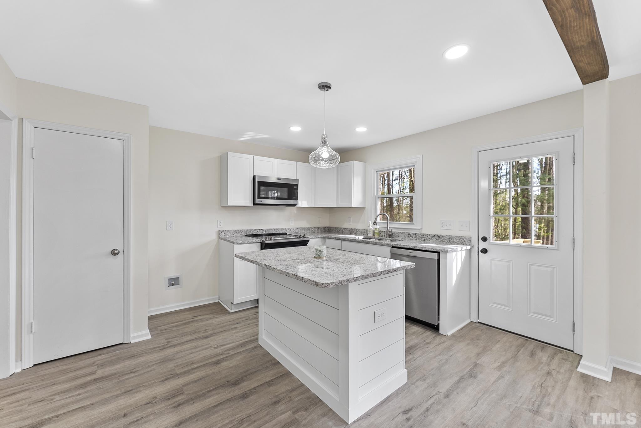 2125 Strebor Street Durham, NC 27705 - Photo 10 of 38 a kitchen with a stove a sink and a refrigerator