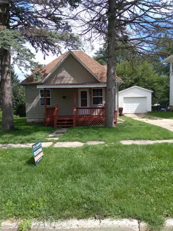 a front view of house with yard and green space