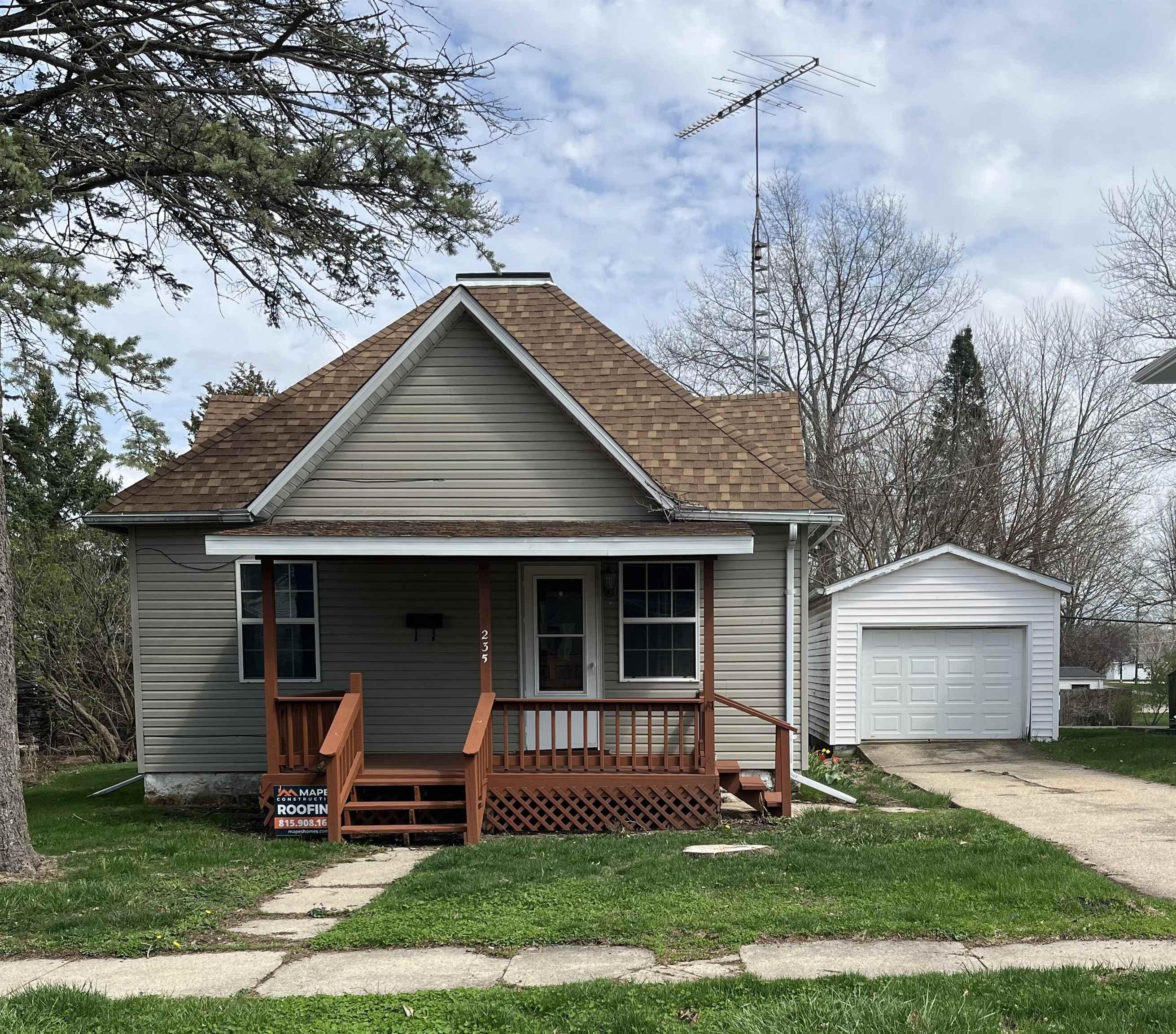 235 North Stockton Street Stockton, IL 61085 - Photo 1 of 18 a front view of a house with a yard
