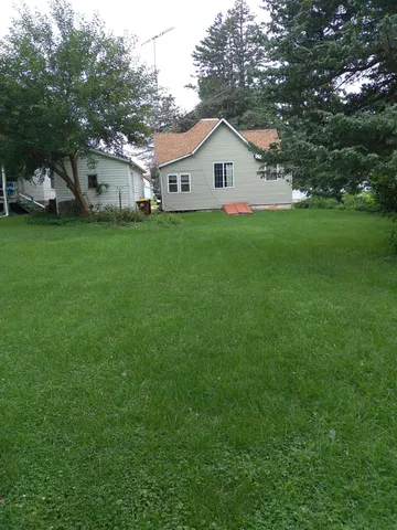a view of house with backyard