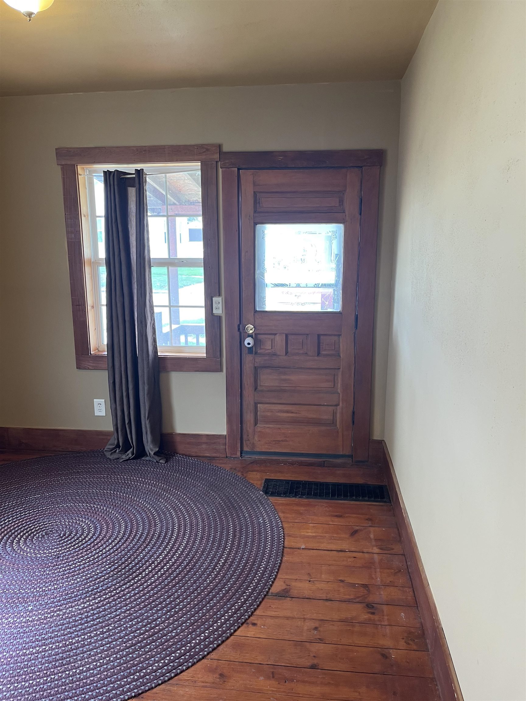 235 North Stockton Street Stockton, IL 61085 - Photo 4 of 18 a view of empty room with wooden floor and fan