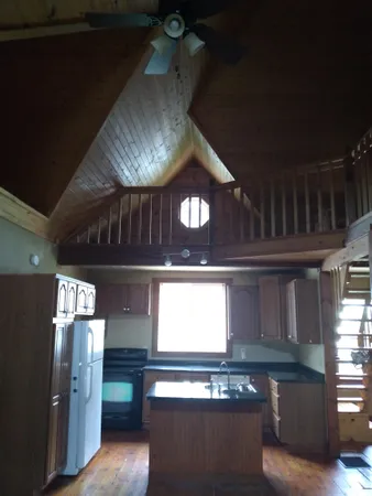 a kitchen with stainless steel appliances granite countertop a stove a refrigerator and a microwave