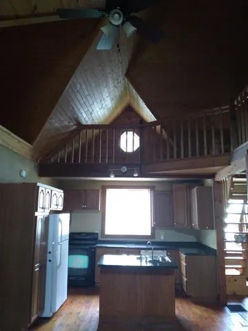 a kitchen with stainless steel appliances granite countertop a stove a refrigerator and a microwave