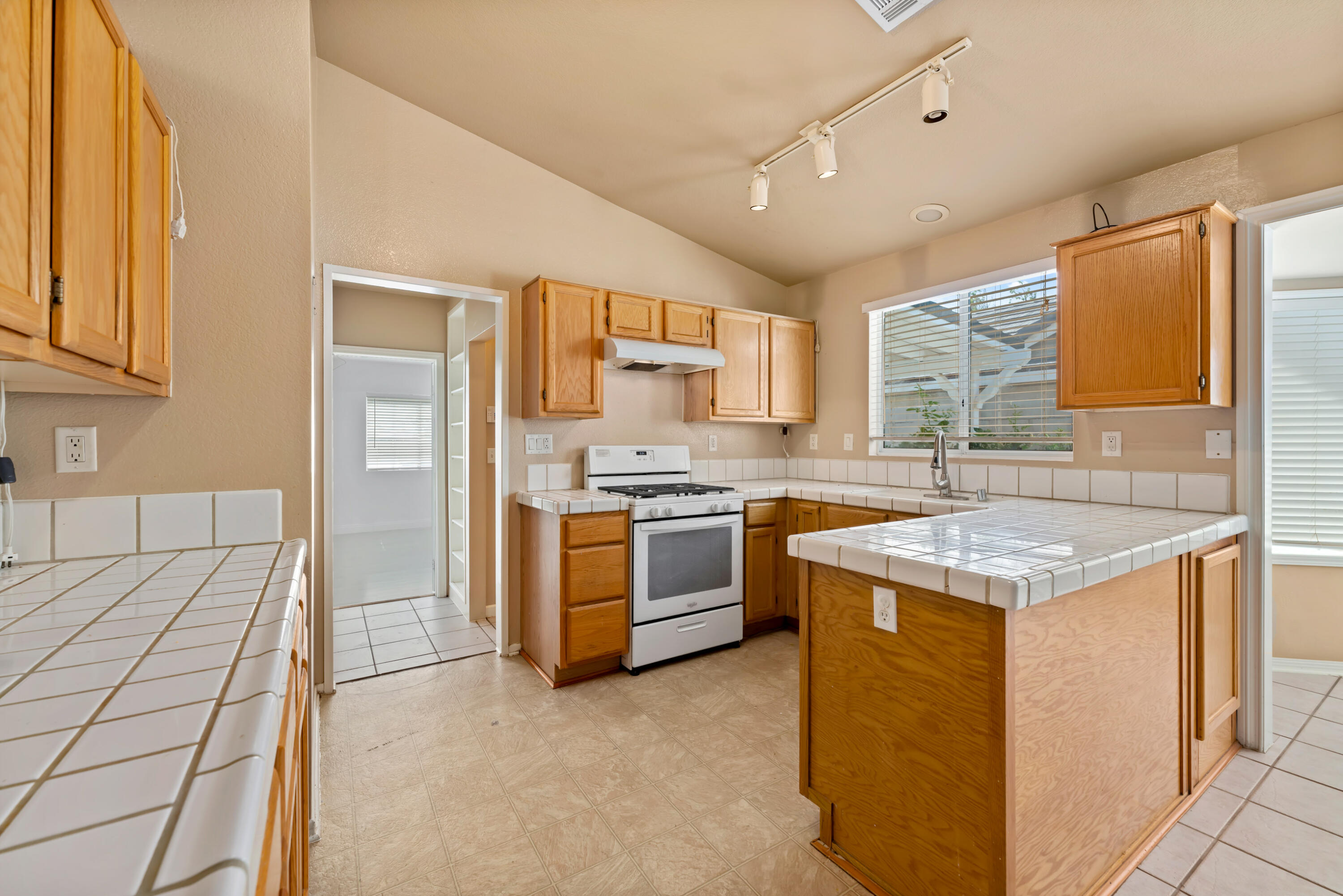 43333 Vineyard Drive Lancaster, CA 93535 - Photo 8 of 31 a kitchen with stainless steel appliances granite countertop a stove a sink and a refrigerator