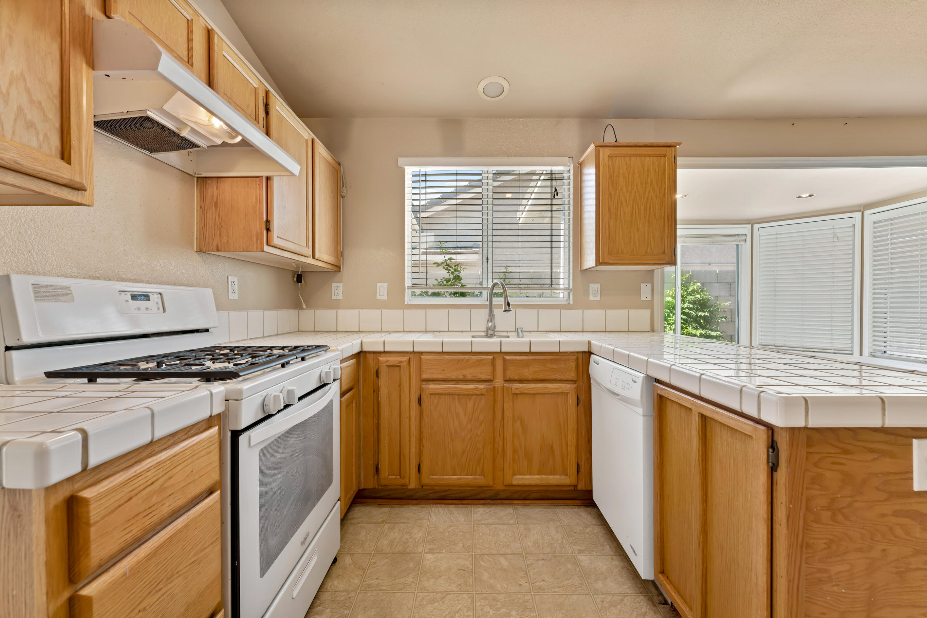 43333 Vineyard Drive Lancaster, CA 93535 - Photo 9 of 31 a kitchen with stainless steel appliances granite countertop a stove a sink and a microwave
