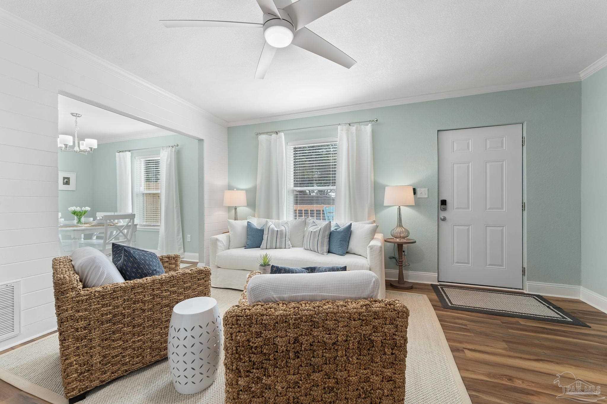 a living room with furniture and a wooden floor