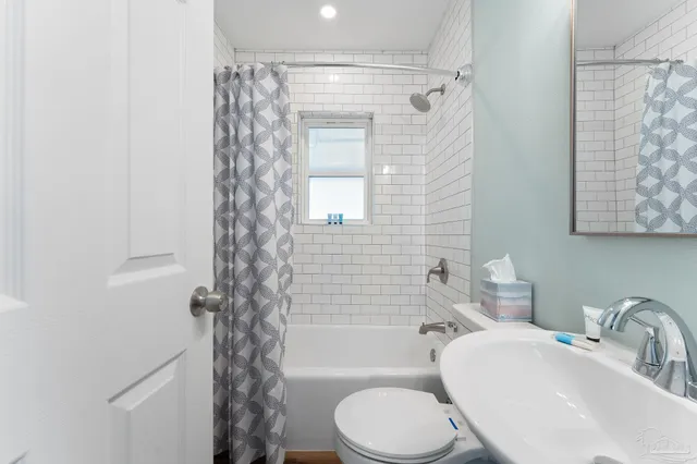 a bathroom with a toilet a sink and bathtub