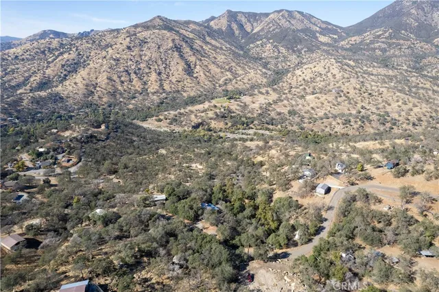 a view of a mountain range with trees in the background