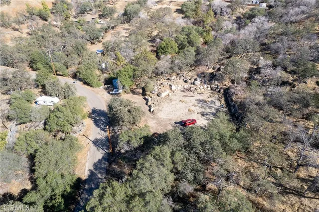 an aerial view of house with yard and mountain view in back