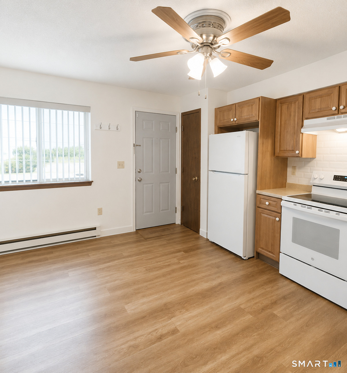 975 Meriden Road, Unit 101 Waterbury, CT 06705 - Photo 14 of 28 a view of a kitchen with a stove a ceiling fan and a window