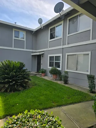 a front view of a house with a garden