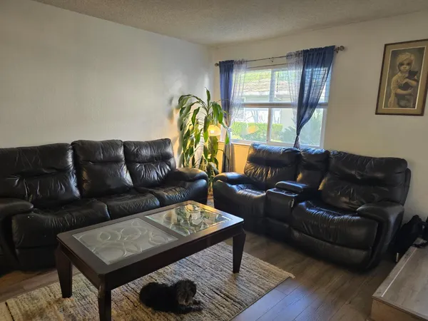 a kitchen with granite countertop a sink stove and cabinets