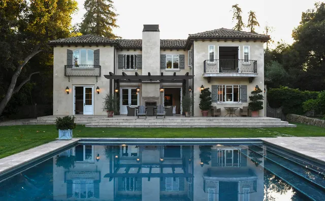 a view of a house with swimming pool and a yard