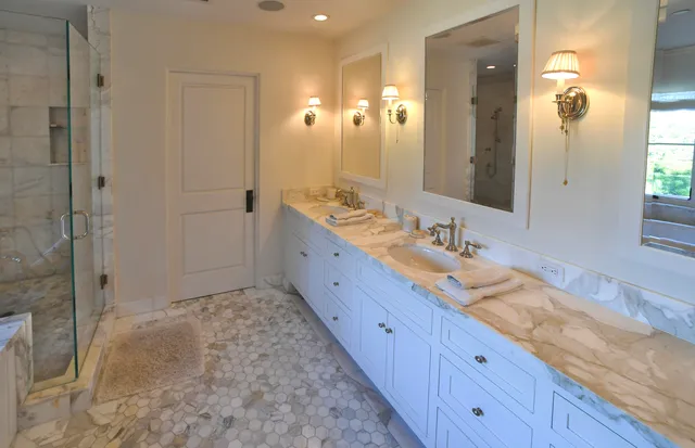 a bathroom with a granite countertop sink mirror and double