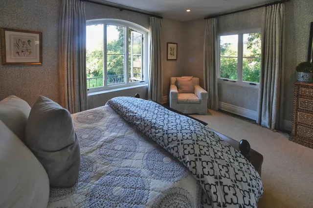 a bedroom with bed and glass window