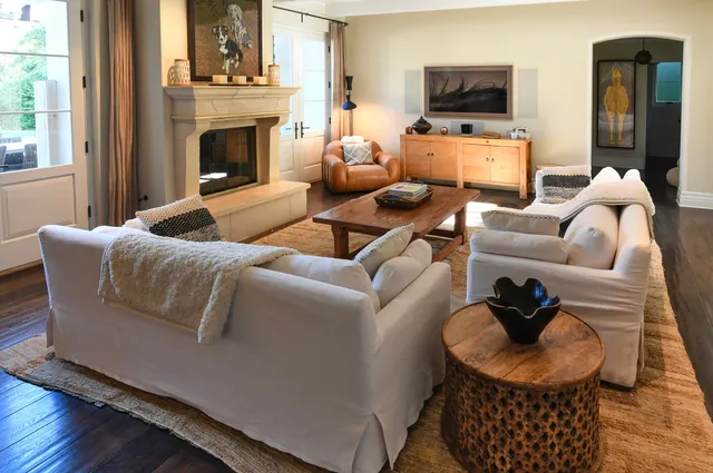 a living room with furniture a flat screen tv and a fireplace