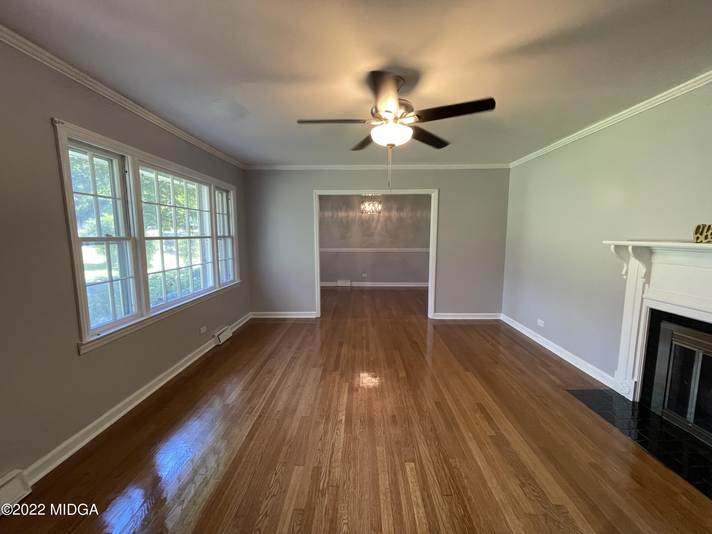 1838 Upper River Road Macon, GA 31211 - Photo 4 of 31 a view of an empty room with wooden floor and a window