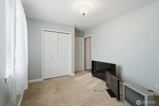 a view of a room with wooden floor and window