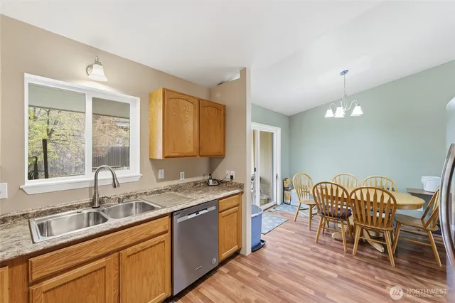 a kitchen with a sink and wooden cabinets