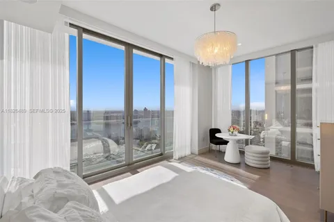 a living room with furniture and a white wall