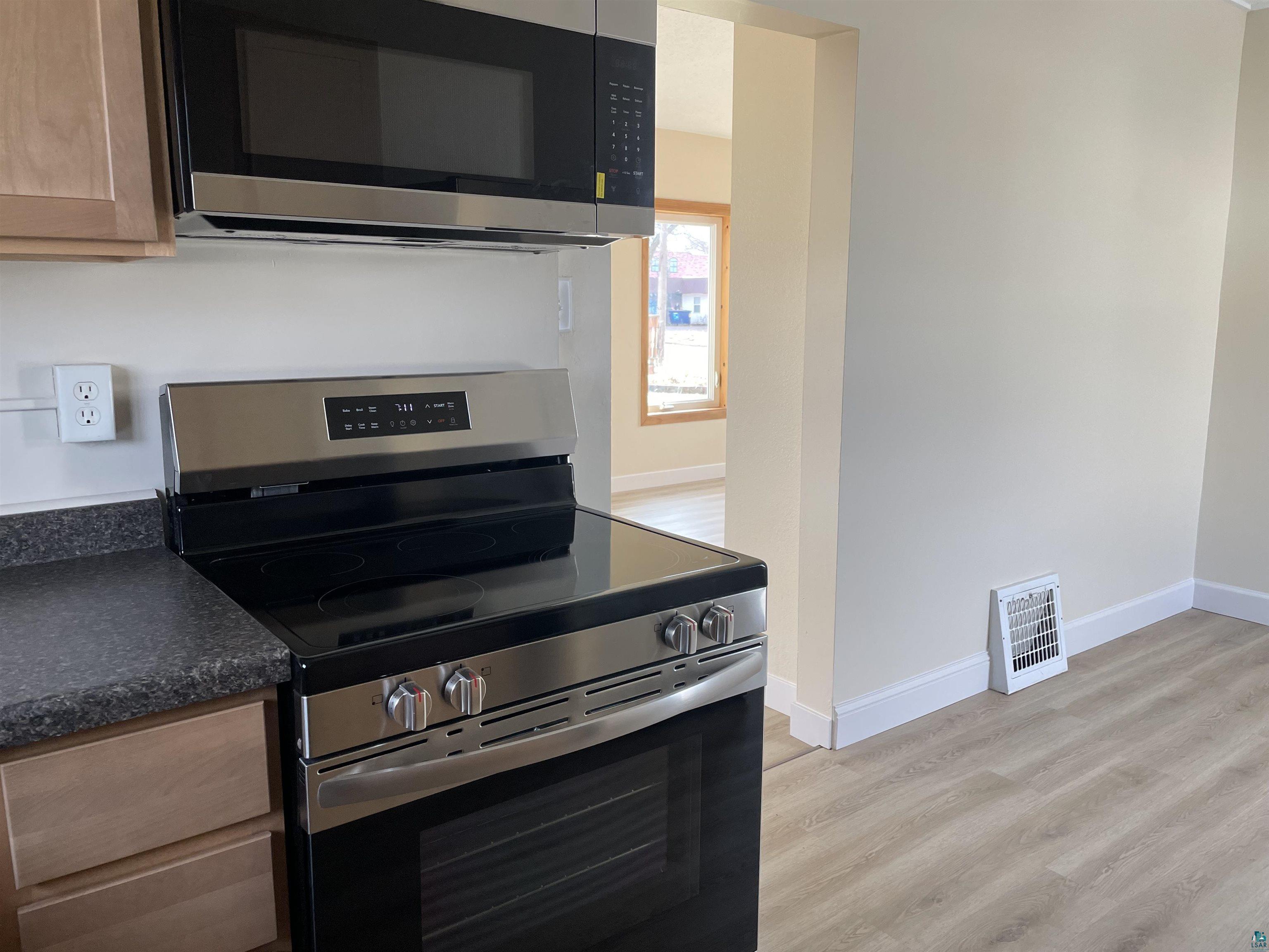 219 4th Street Proctor, MN 55810 - Photo 11 of 25 Kitchen featuring stainless steel appliances and light hardwood / wood-style floors