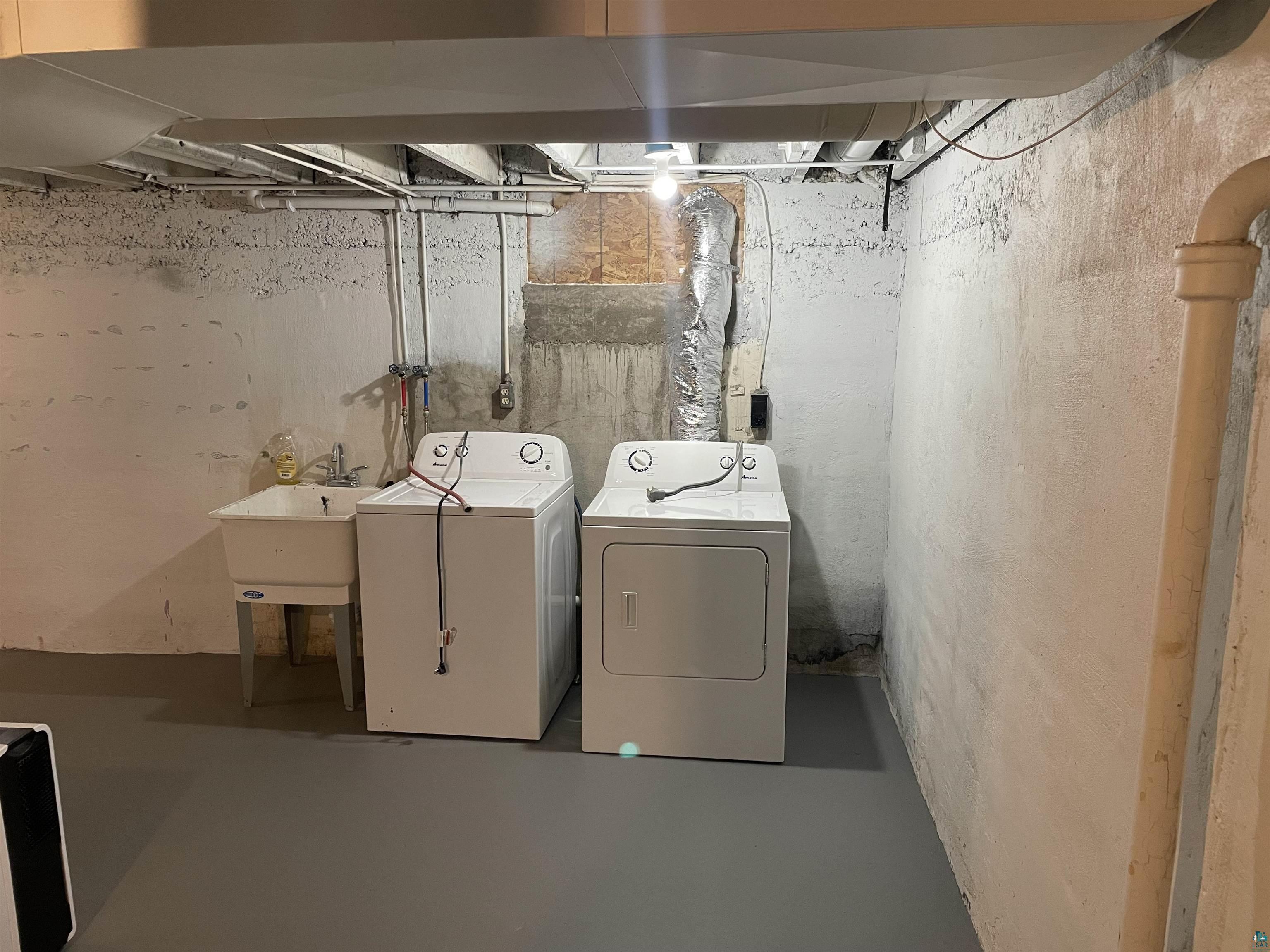 219 4th Street Proctor, MN 55810 - Photo 13 of 25 Laundry area featuring washing machine and clothes dryer and sink