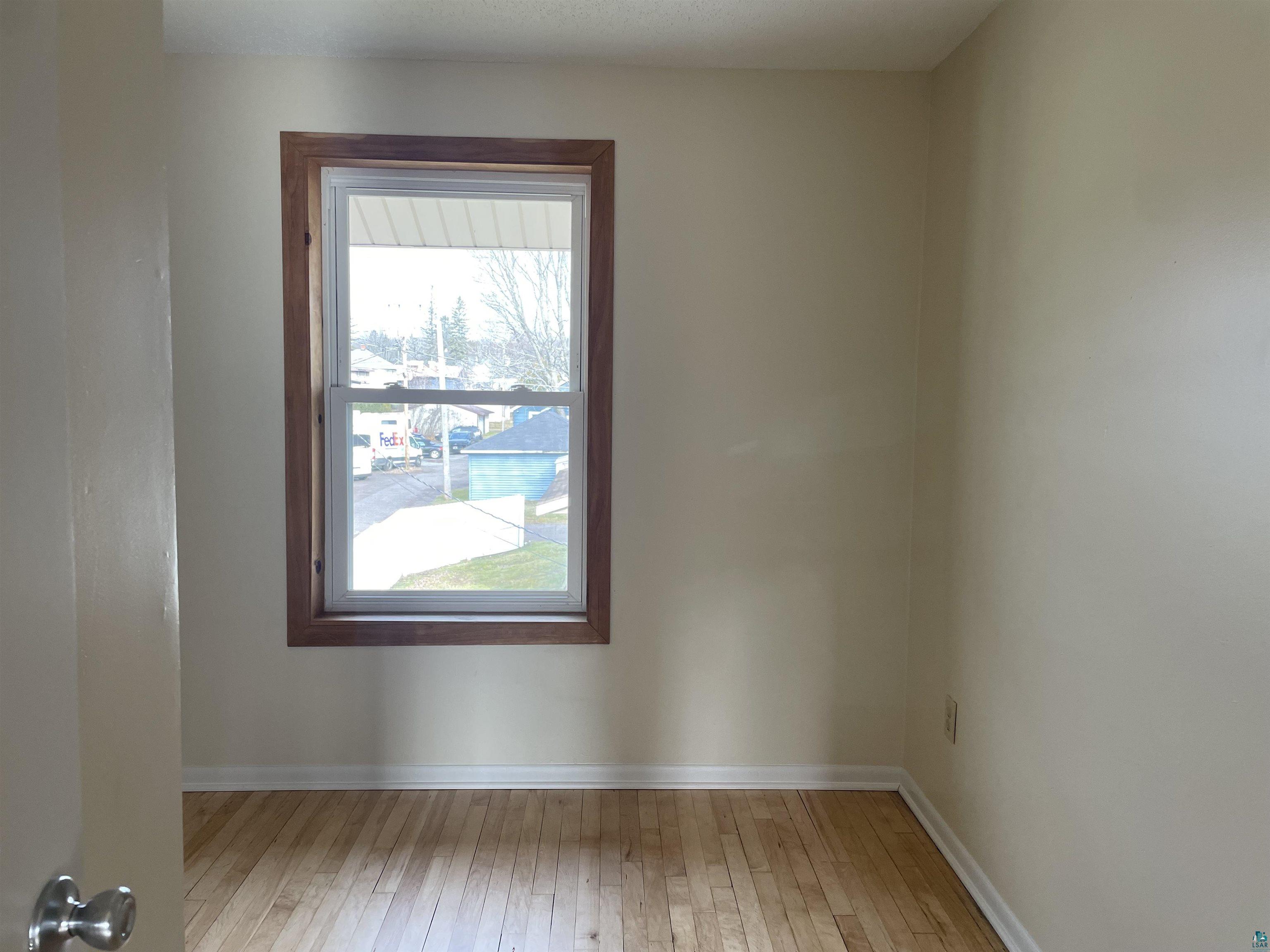 219 4th Street Proctor, MN 55810 - Photo 16 of 25 Empty room featuring wood-type flooring