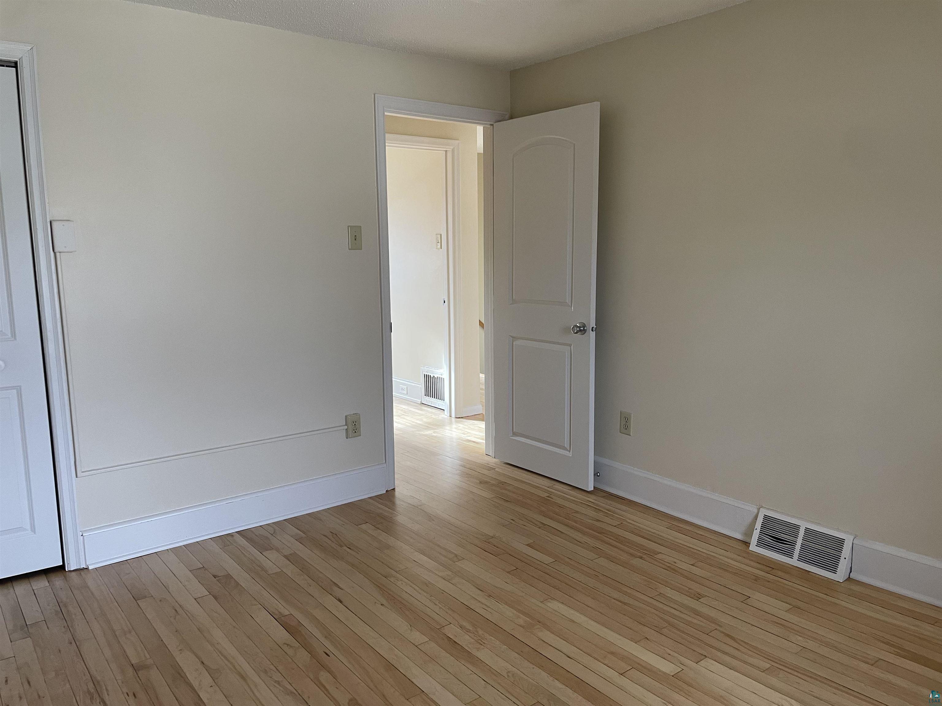 219 4th Street Proctor, MN 55810 - Photo 22 of 25 Empty room with light hardwood / wood-style floors