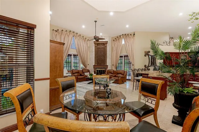 a living room with furniture a flat screen tv and kitchen view