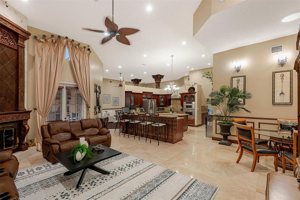 Davie Davie, FL 33330 - Photo 15 of 57 a living room with furniture a fireplace and a chandelier
