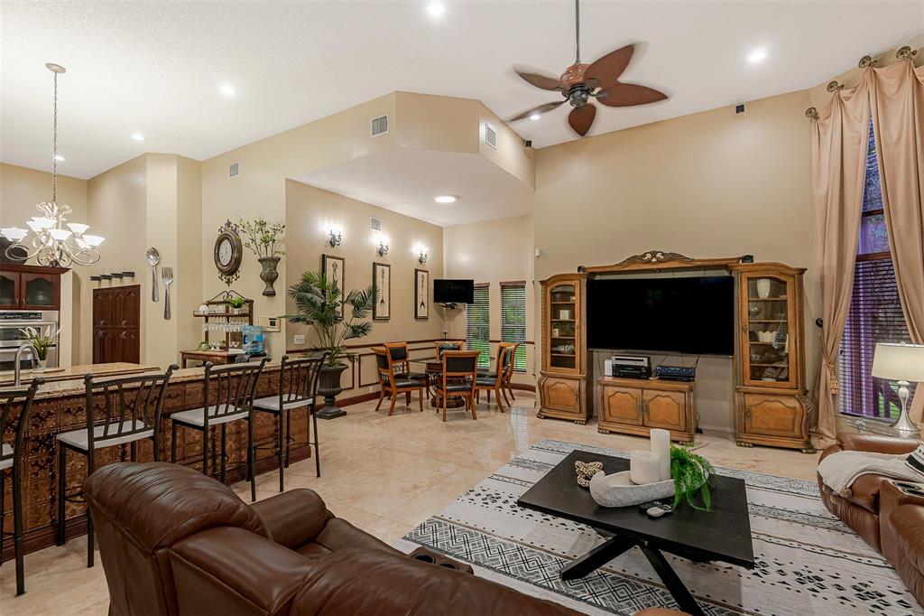 Davie Davie, FL 33330 - Photo 16 of 57 a living room with furniture a flat screen tv and kitchen view