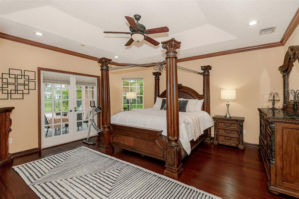 Davie Davie, FL 33330 - Photo 20 of 57 a bedroom with a large bed a chandelier and windows