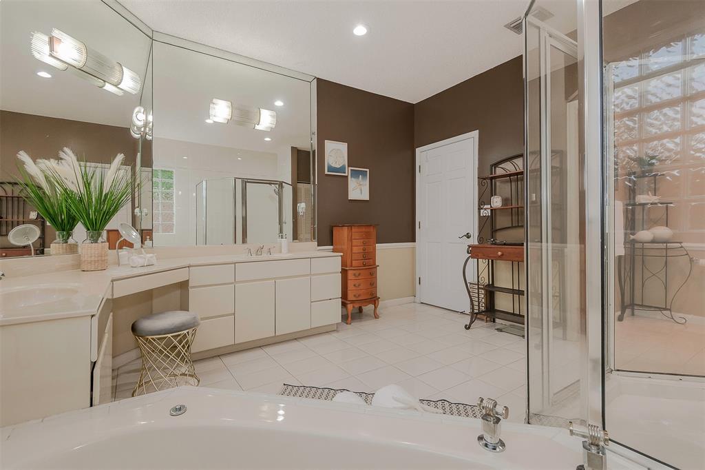 Davie Davie, FL 33330 - Photo 22 of 57 a bathroom with a sink a mirror and a shower