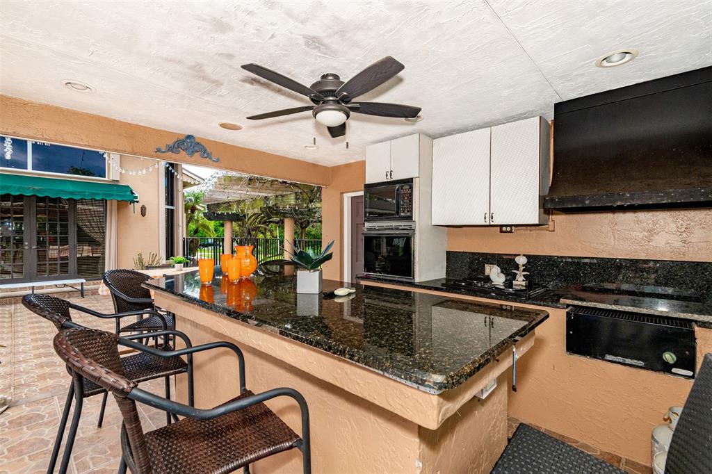 Davie Davie, FL 33330 - Photo 36 of 57 a kitchen with stainless steel appliances granite countertop a sink a stove and a microwave