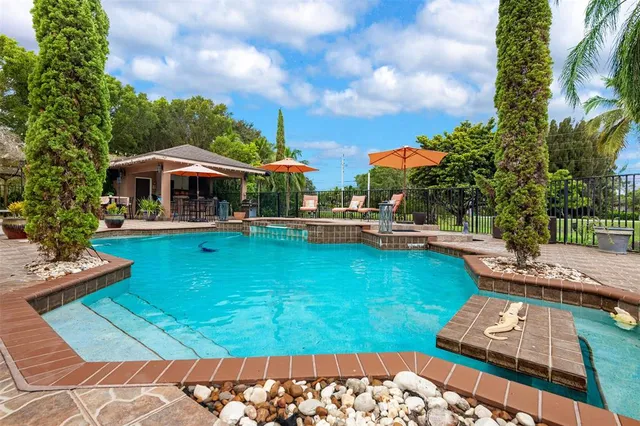 an aerial view of a pool and trees