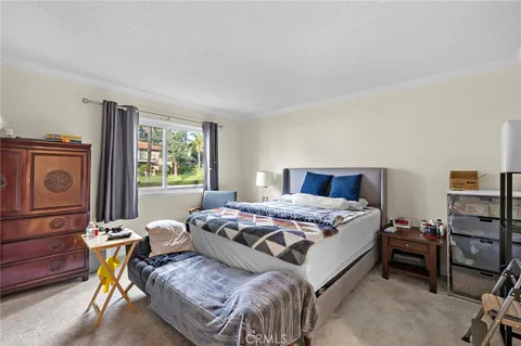 a bedroom with a bed and a dresser in it