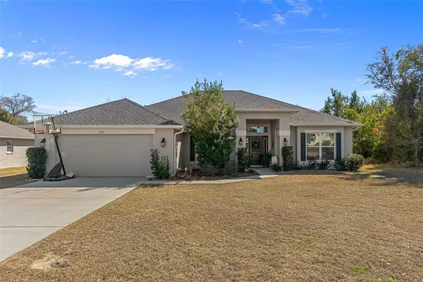 a front view of a house with a yard and garage