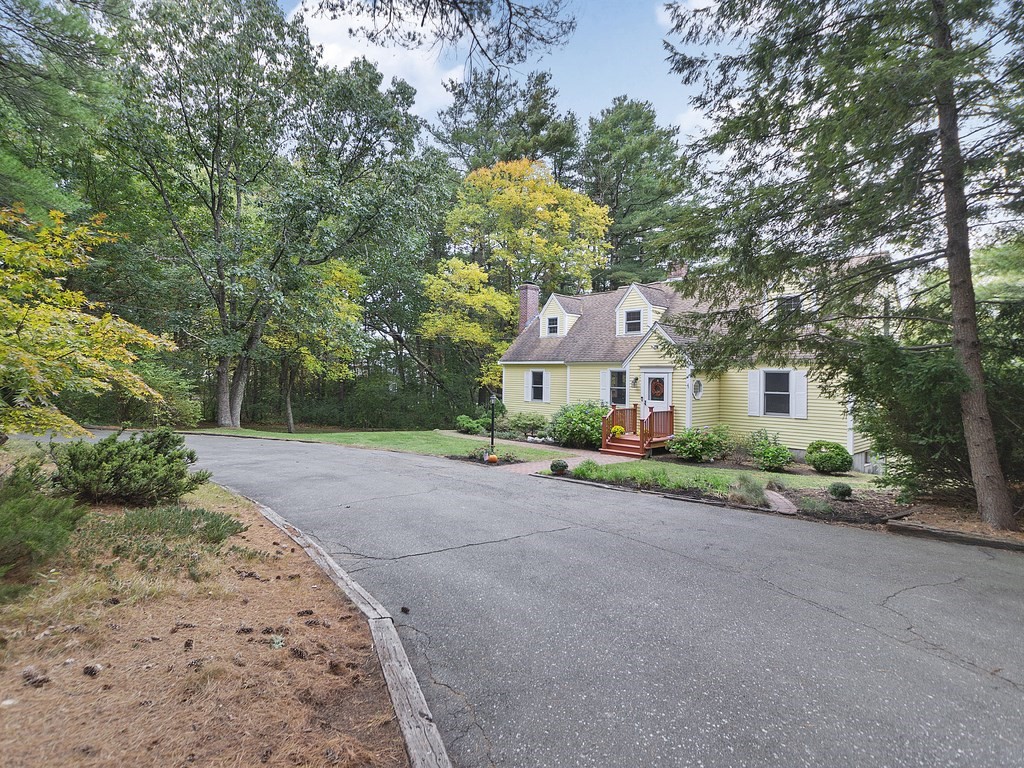 122 Haverhill Road Topsfield, MA 01983 - Photo 3 of 36 a front view of a house with a yard and a garage