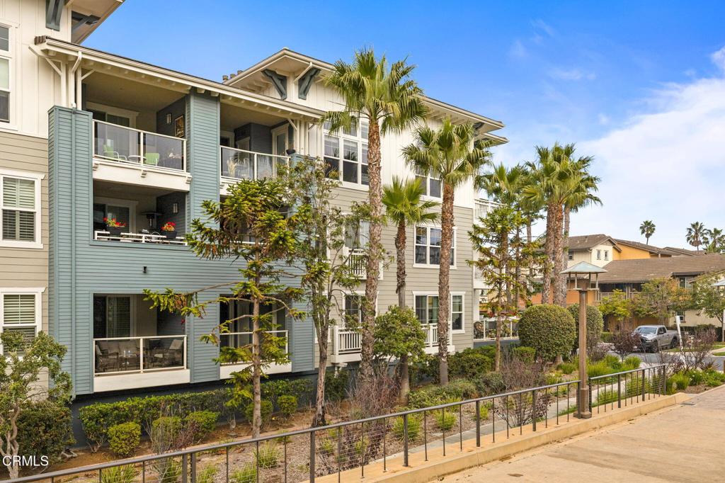 1423 Windshore Way Oxnard, CA 93035 - Photo 61 of 77 a front view of a building with glass windows and a yard