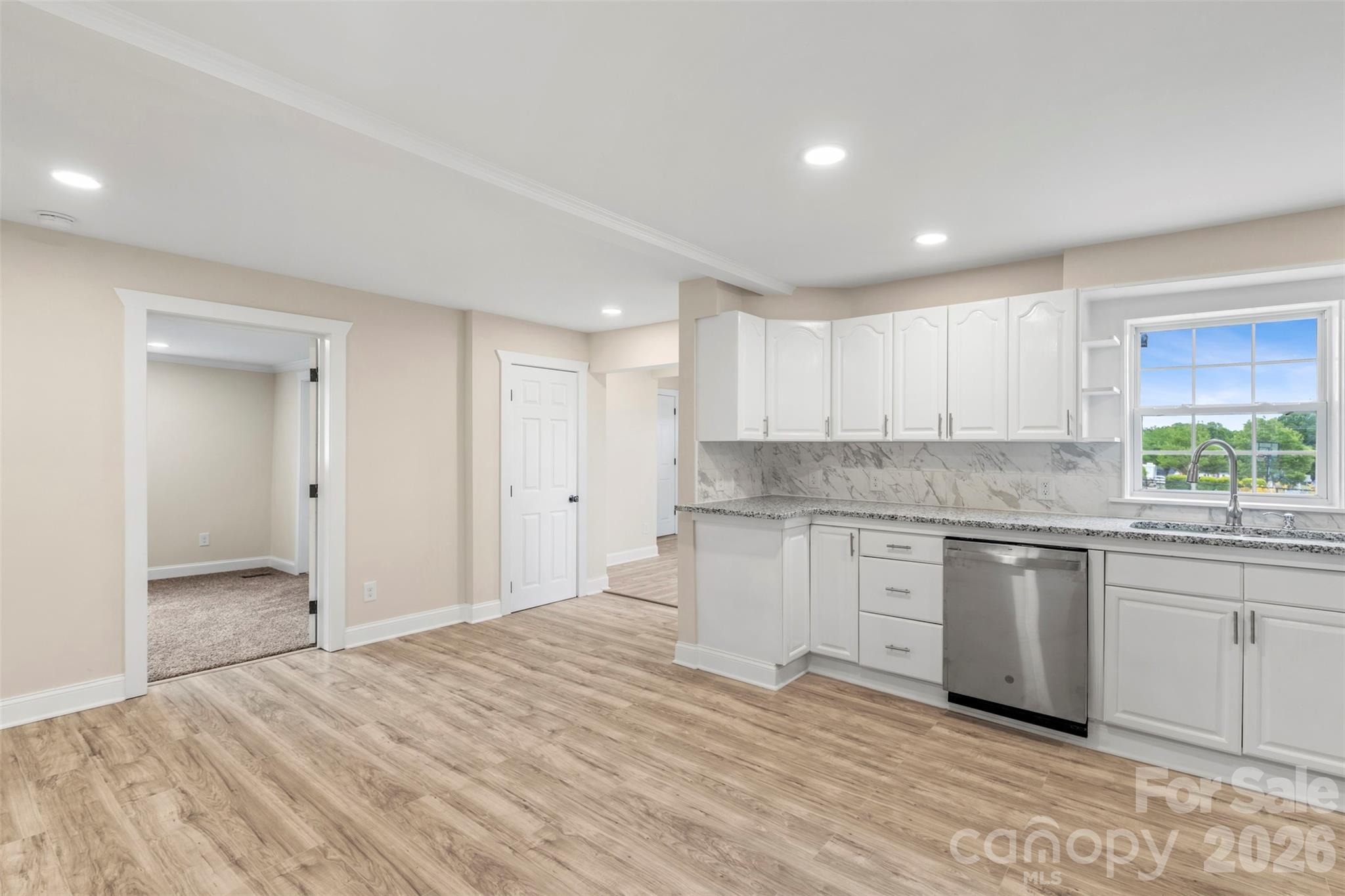 2480 Artz Road Salisbury, NC 28146 - Photo 18 of 33 a kitchen with granite countertop white cabinets and white appliances
