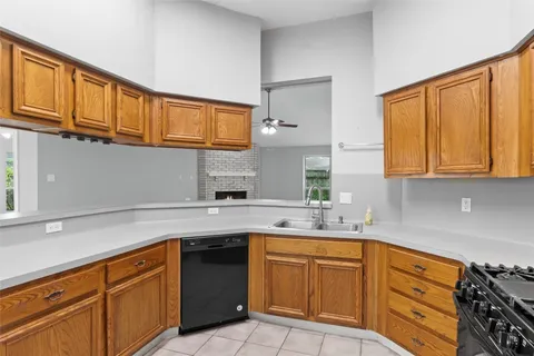 a kitchen with stainless steel appliances granite countertop a sink stove and cabinets