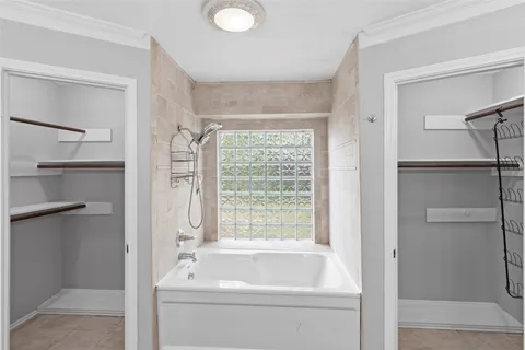a bathroom with a bathtub a shower and a vanity
