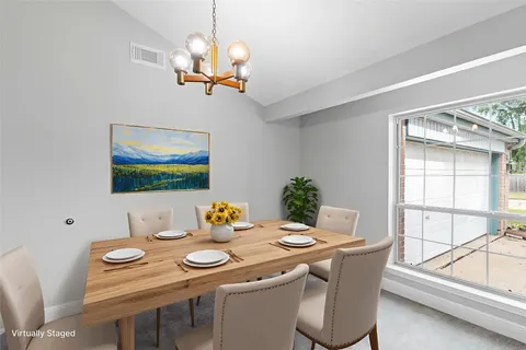 a dining room with furniture and window