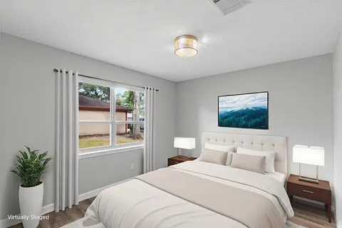 a bedroom with a bed and a potted plant